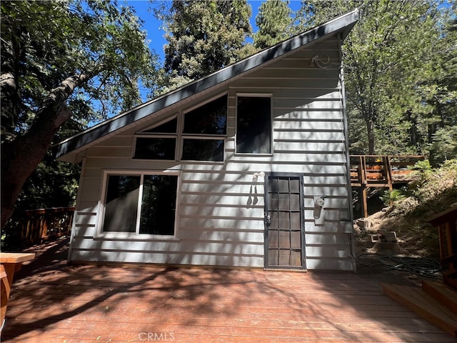 view of side of property featuring a wooden deck