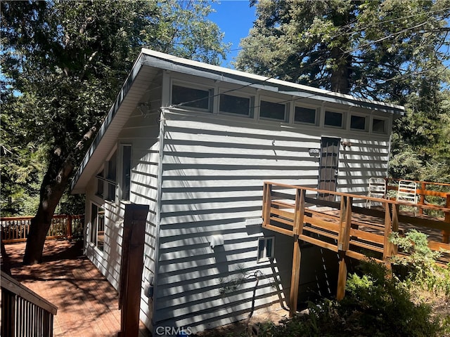 view of property exterior with a deck