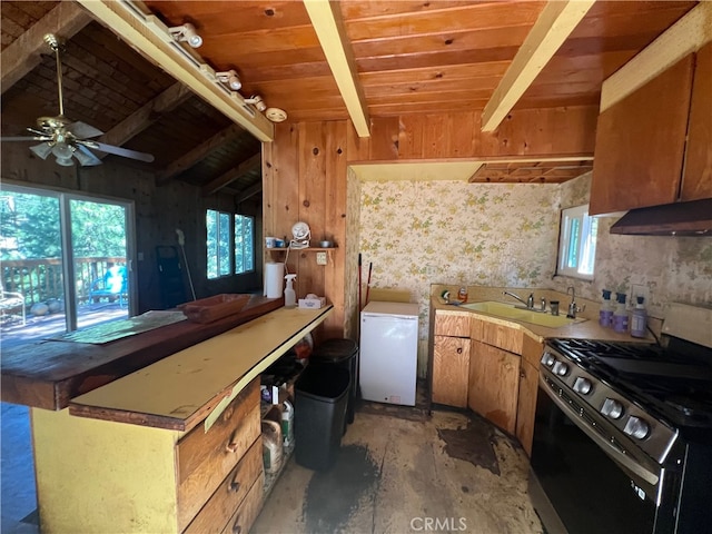 kitchen featuring lofted ceiling with beams, ceiling fan, wooden ceiling, black range with gas cooktop, and white fridge