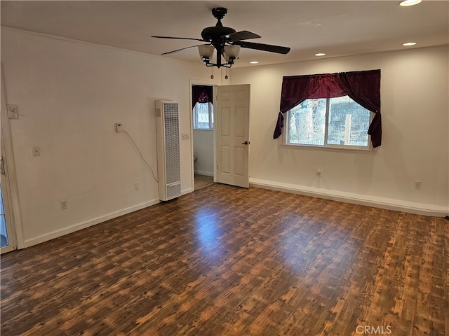 empty room featuring ceiling fan and dark hardwood / wood-style flooring