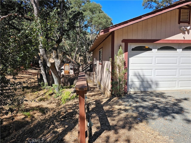 view of side of home featuring a garage