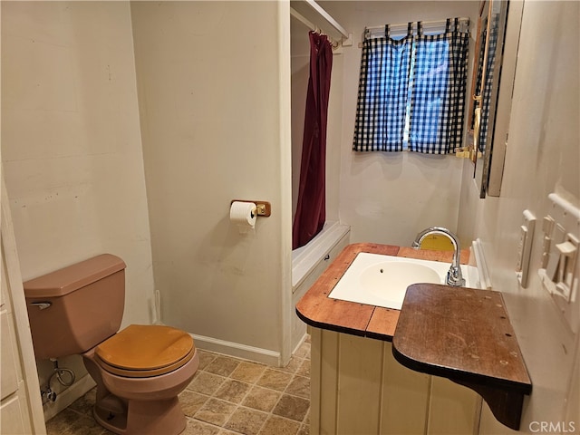 bathroom with vanity, toilet, and walk in shower