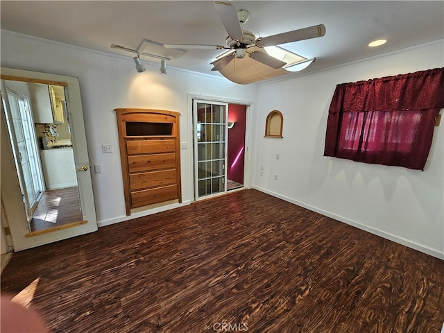 empty room with dark hardwood / wood-style flooring, crown molding, and ceiling fan