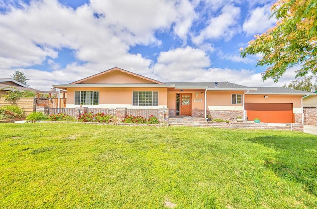 ranch-style house featuring a front yard and a garage