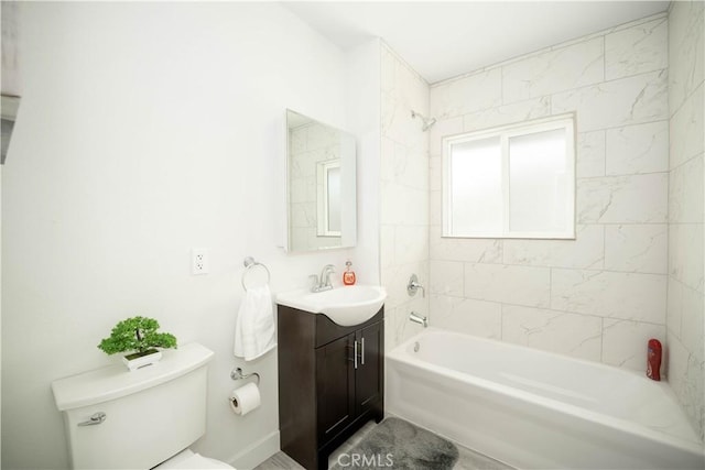 full bathroom with toilet, tiled shower / bath combo, and vanity