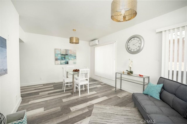 living room featuring hardwood / wood-style floors and a wall mounted air conditioner