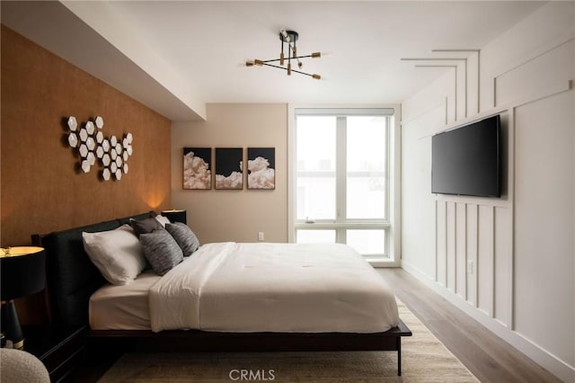 380 Cordova St Unit 305, Pasadena, CA 91101 - bedroom with wood finished floors, a chandelier, and baseboards
