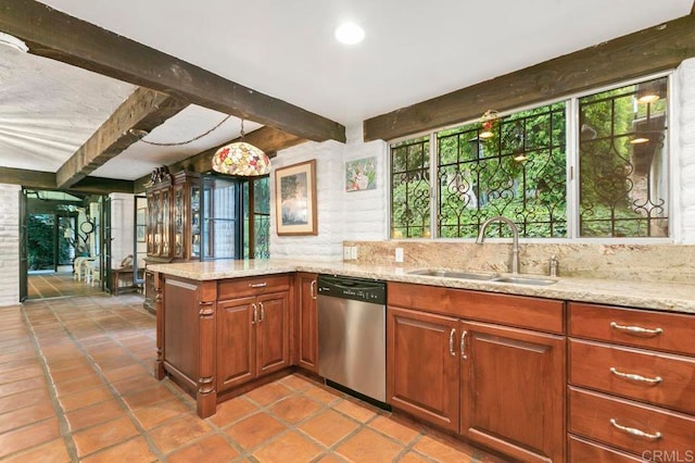 kitchen with sink, beamed ceiling, pendant lighting, stainless steel dishwasher, and light stone counters