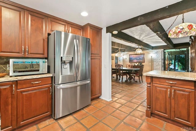 kitchen with beamed ceiling, hanging light fixtures, stainless steel fridge with ice dispenser, light tile patterned floors, and light stone counters