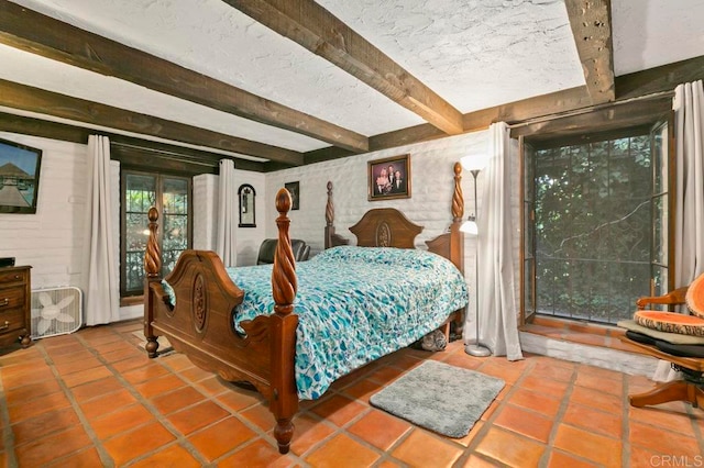 bedroom with beamed ceiling and tile patterned flooring