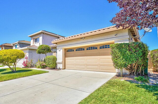 view of front of house with a garage and a front lawn