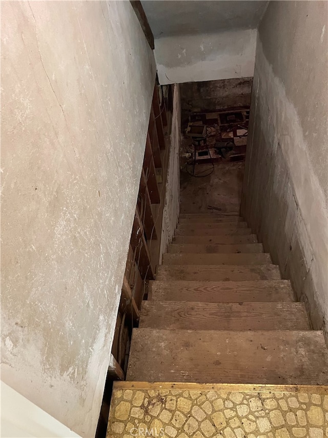 staircase with wood-type flooring