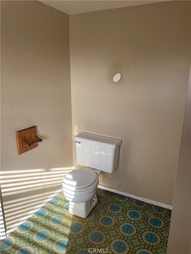 bathroom with tile patterned flooring and toilet