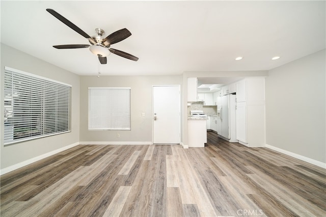 unfurnished living room with light hardwood / wood-style floors and ceiling fan