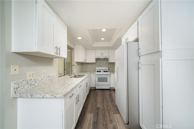 kitchen with sink, white cabinetry, white appliances, a raised ceiling, and dark hardwood / wood-style flooring