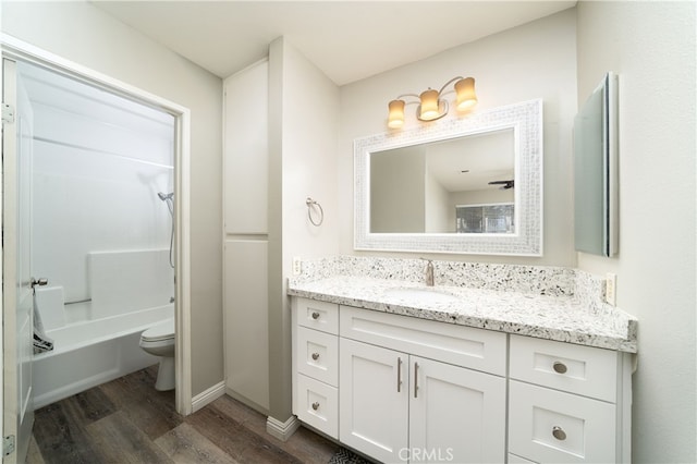 full bathroom featuring shower / bathtub combination, vanity, toilet, and hardwood / wood-style flooring