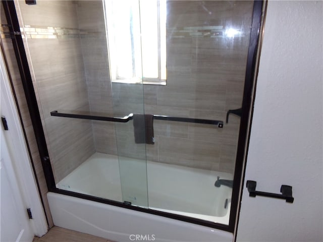 bathroom featuring enclosed tub / shower combo