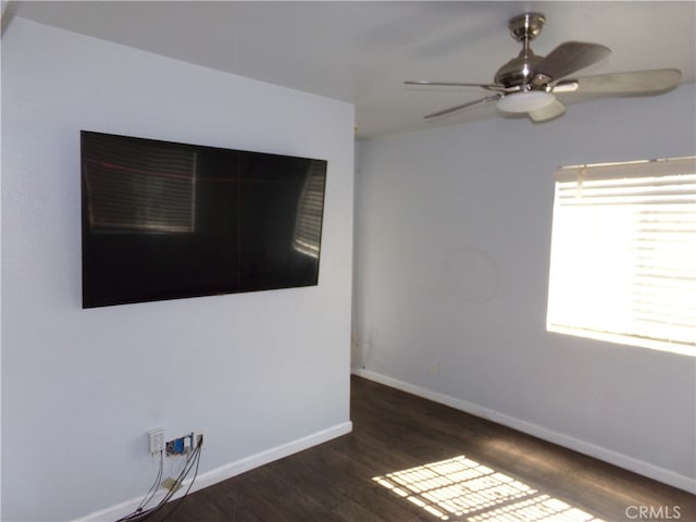 empty room featuring ceiling fan and dark hardwood / wood-style flooring