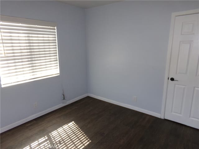 spare room featuring dark hardwood / wood-style floors