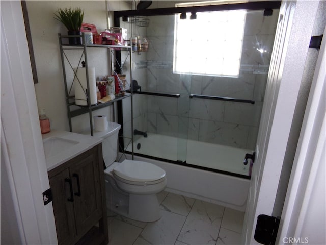 full bathroom featuring vanity, enclosed tub / shower combo, and toilet