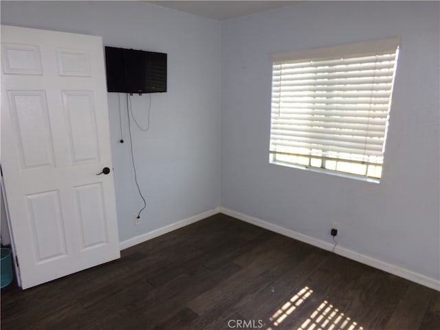 empty room featuring dark wood-type flooring