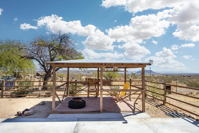 view of patio with a mountain view and an outbuilding