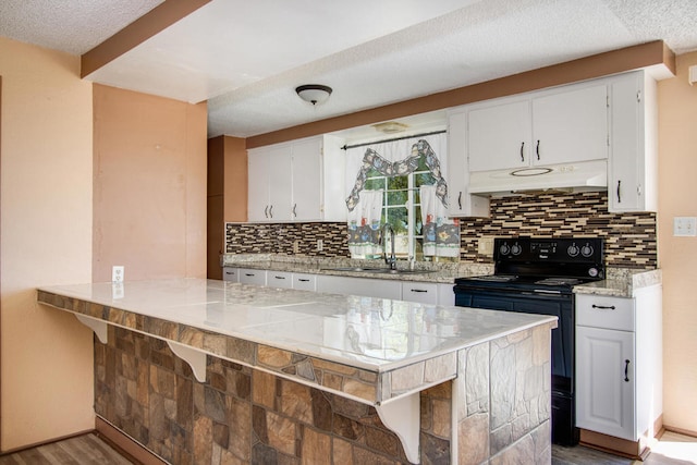 kitchen with white cabinetry, sink, wood-type flooring, and black / electric stove