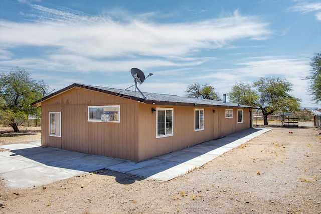 view of side of property featuring a patio area