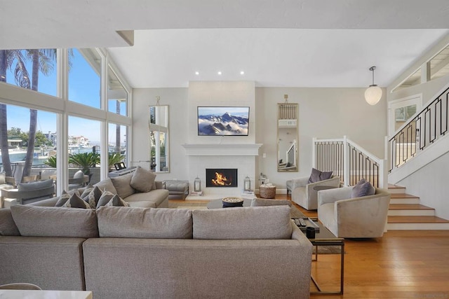 living room featuring a towering ceiling and hardwood / wood-style flooring