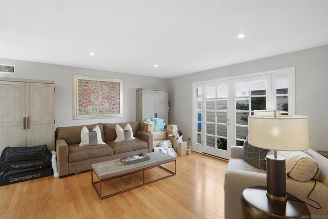 living room with french doors and light hardwood / wood-style flooring