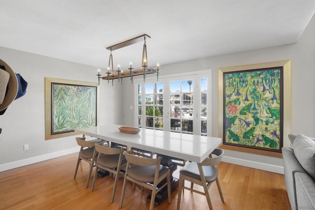 dining room featuring light hardwood / wood-style floors and a chandelier