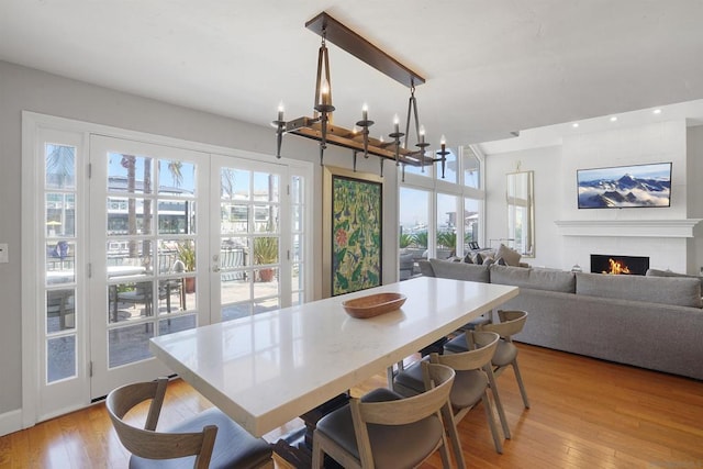 dining space featuring a notable chandelier and light wood-type flooring