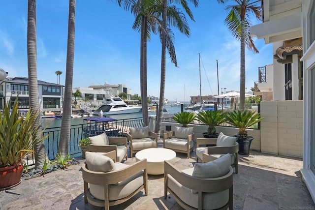 view of patio / terrace featuring a balcony and a water view