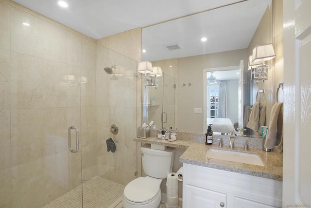 bathroom featuring walk in shower, vanity, and toilet