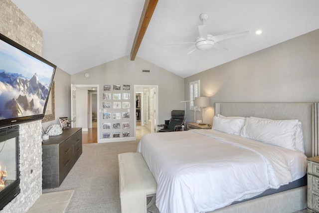 bedroom with ceiling fan, light colored carpet, a fireplace, and lofted ceiling with beams