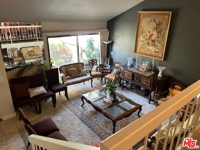 living room with vaulted ceiling and tile patterned floors