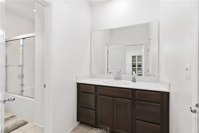 bathroom with vanity, bath / shower combo with glass door, and tile patterned floors