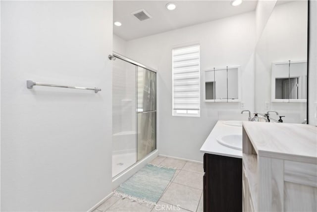 bathroom with vanity, a shower with shower door, and tile patterned floors