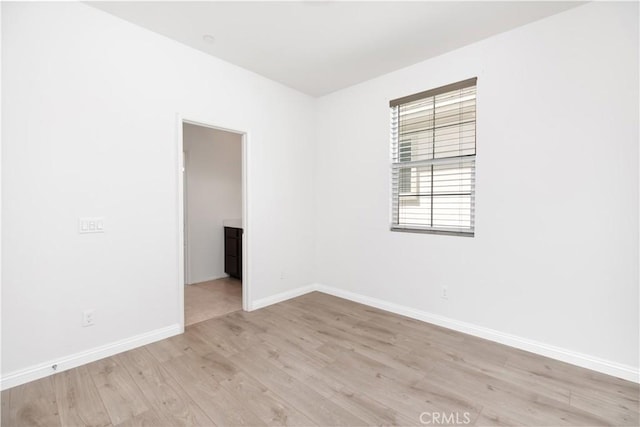 spare room featuring light hardwood / wood-style flooring