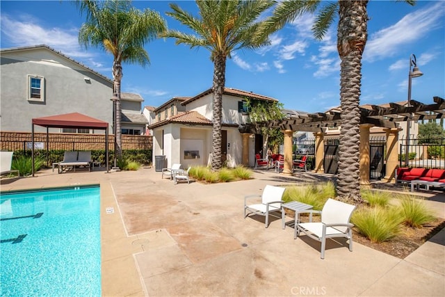 back of property featuring a pergola, a patio, central AC unit, a community pool, and a gazebo