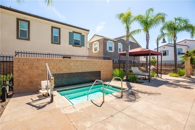 view of swimming pool featuring an in ground hot tub