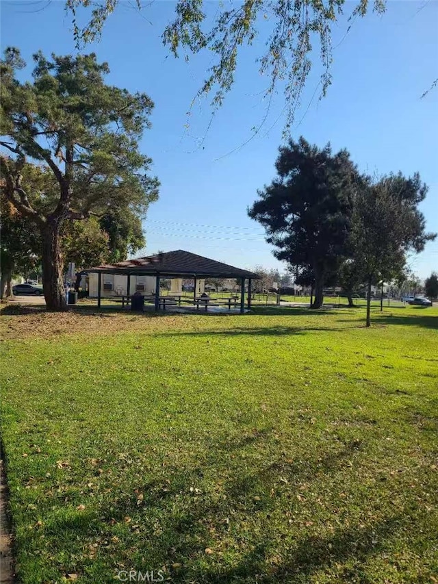 view of property's community with a gazebo and a yard