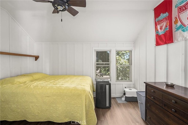 bedroom with vaulted ceiling, ceiling fan, and hardwood / wood-style flooring