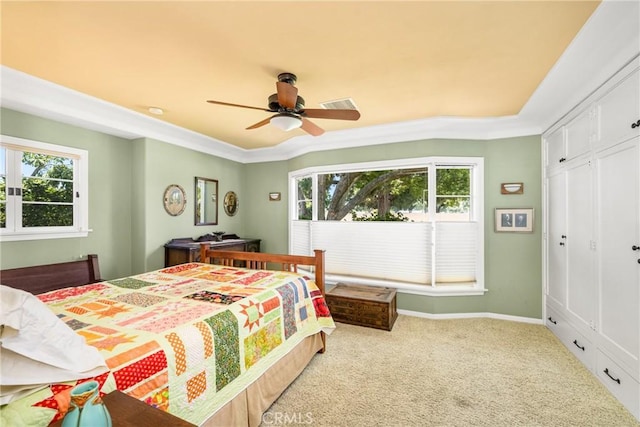 carpeted bedroom featuring ceiling fan and a closet