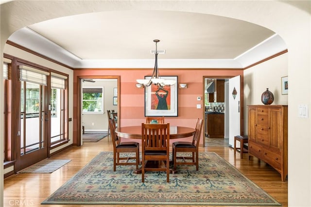 dining room with an inviting chandelier, light hardwood / wood-style flooring, and french doors