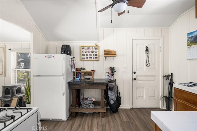 kitchen featuring ceiling fan, tile counters, dark wood-type flooring, vaulted ceiling, and white refrigerator