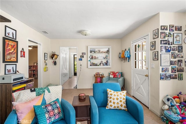 sitting room featuring light colored carpet