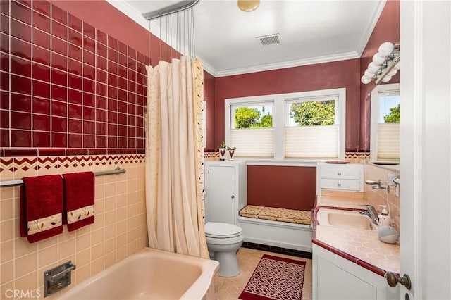 full bathroom featuring toilet, vanity, tile walls, tile patterned floors, and ornamental molding