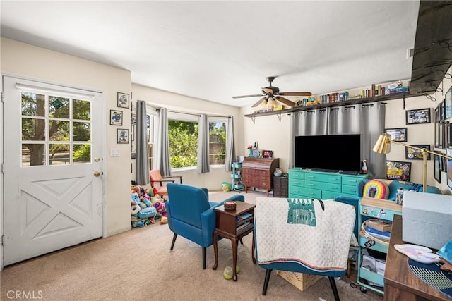 living room with ceiling fan, a wealth of natural light, and carpet floors