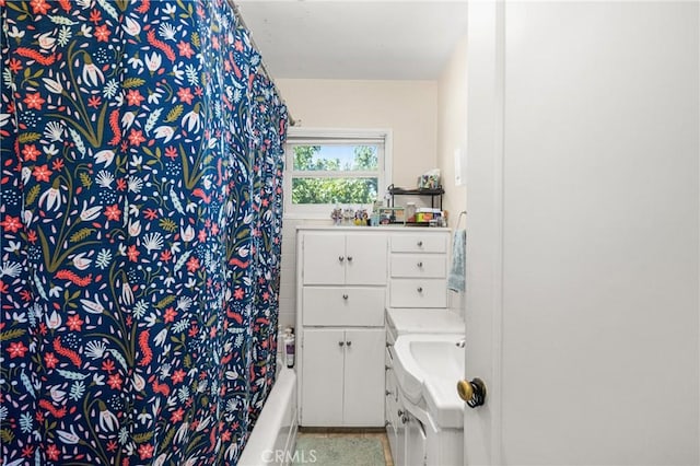 bathroom featuring walk in shower and vanity